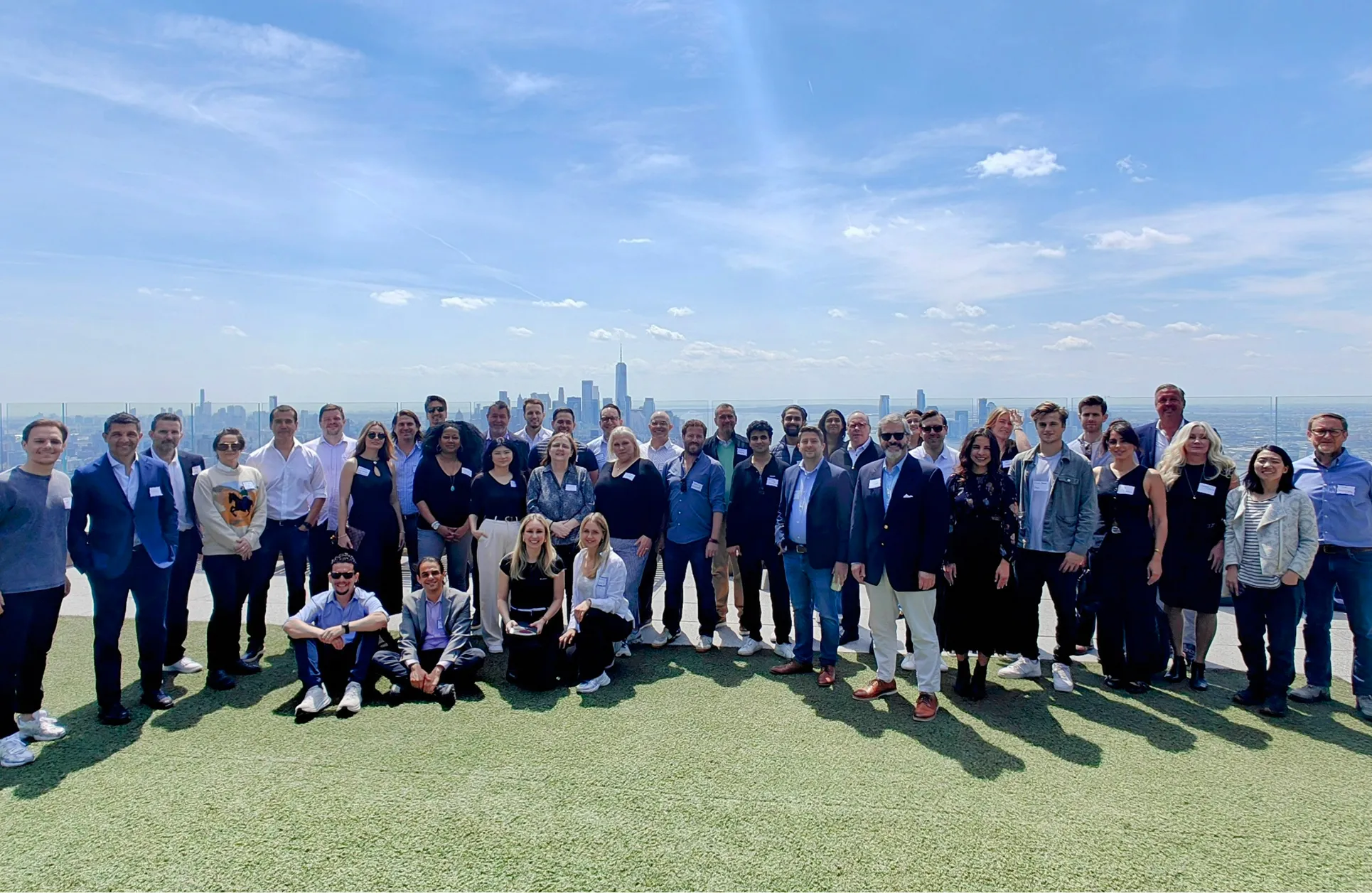 GTM Executive Roundtable attendees on a NYC rooftop with the Manhattan skyline behind them