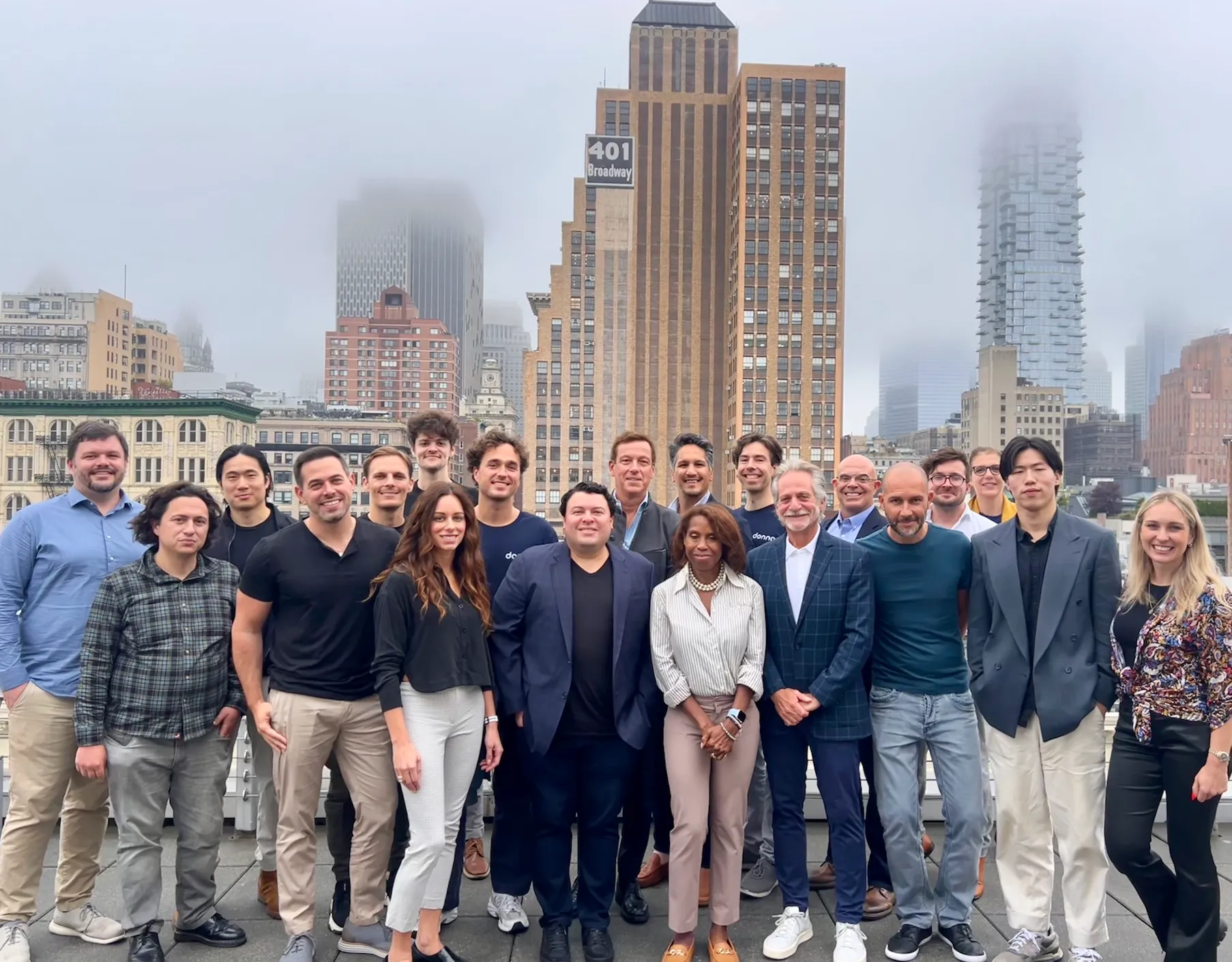 Roughly twenty GTM operators on a NYC rooftop with Manhattan towers behind them
