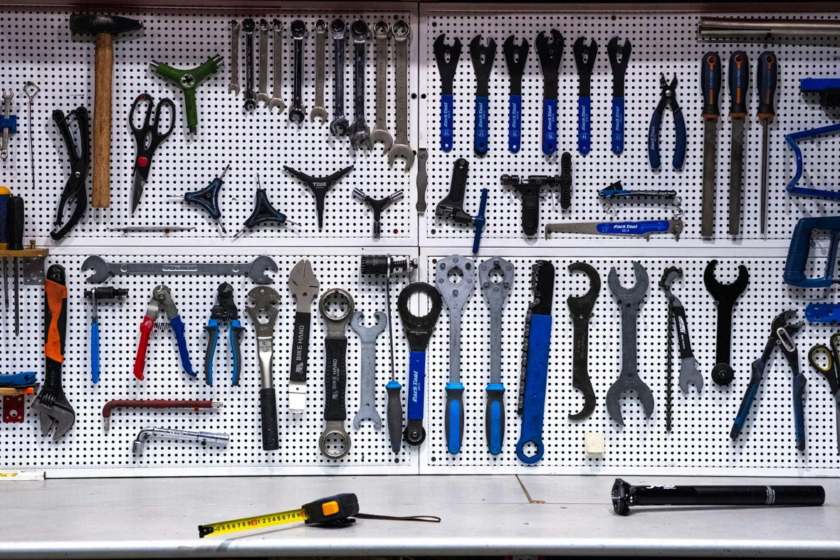 A pegboard wall neatly organized with a full set of tools